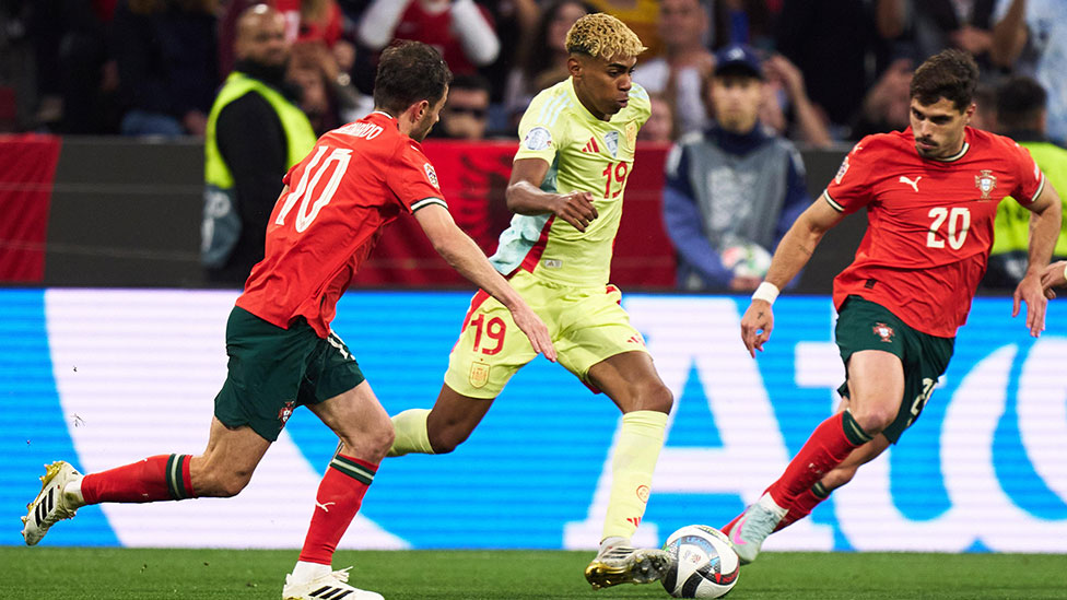 Lamine Yamal in action for Spain, dribbling past Portugal players